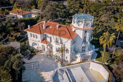 An aerial view of a large, elegant villa with a re