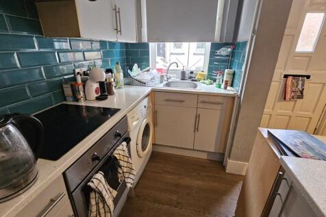 Bright and well-equipped kitchen featuring mode...