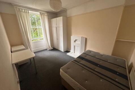 Bright, well-proportioned bedroom with a large ...