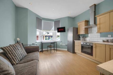 Modern open plan kitchen with bright bay window...
