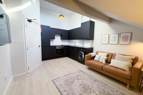 Bright, modern open-plan living area with a com...