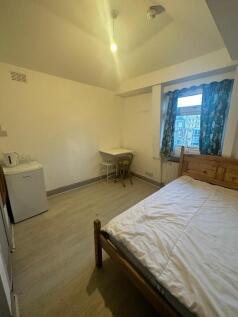 Spacious bedroom with study area and window...