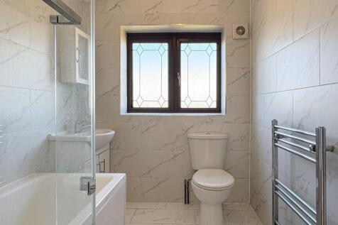Elegant bathroom with marble tiles and a bath...