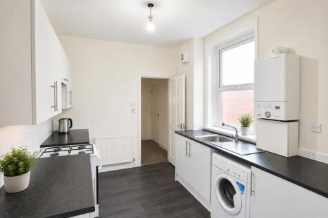 Bright modern kitchen with integrated appliance...