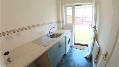 Bright galley kitchen with a large sink, counte...