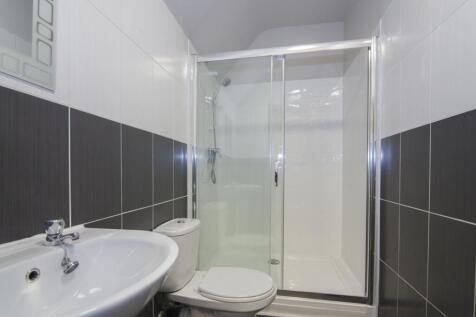 A modern bathroom featuring a sleek shower encl...