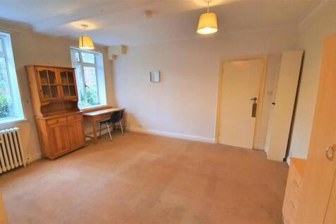 Spacious room with study desk and natural light...