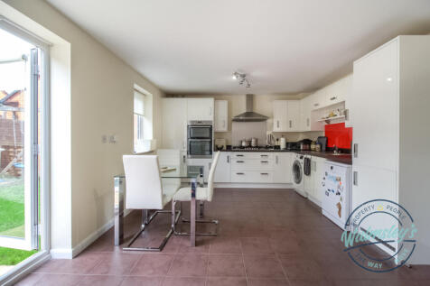 Kitchen dining with french doors to garden