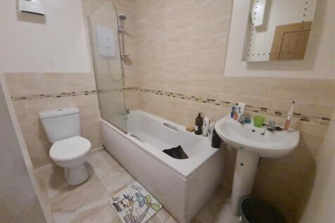 Bright, modern bathroom with a full-size bathtu...