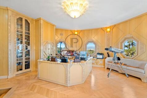 A luxurious home office features ornate wood panel