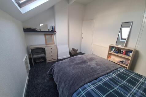 A bright and comfortable master bedroom featuri...