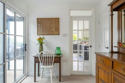 Hallway with access to kitchen, sunroom, living ar