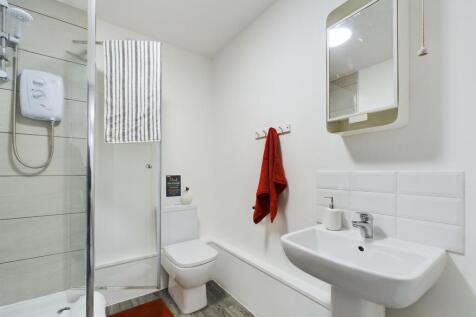 Modern bathroom with a clean white sink, a larg...