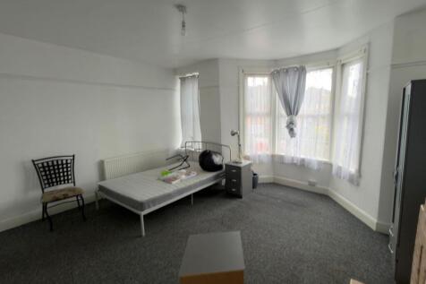 Bright, spacious bedroom with a large bay windo...