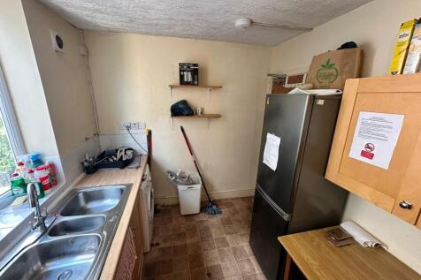 A functional kitchenette with ample space for c...