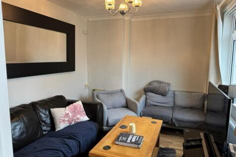 Cozy furnished living room with mixed seating i...