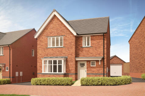 A red brick house with a bay window and white door sits behind a neatly trimmed hedge