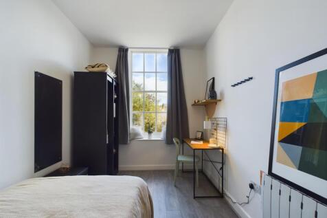 A bright and inviting double bedroom featuring ...