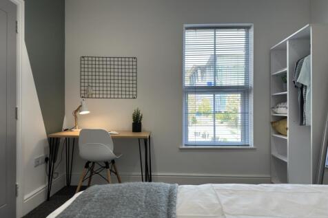 A bright and inviting double bedroom featuring ...