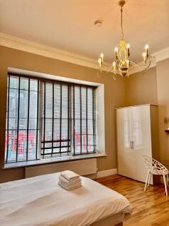 Bright room with large bay window and wardrobe...