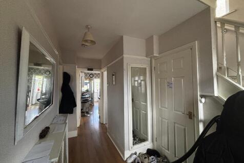 Bright and welcoming hallway with large mirror...