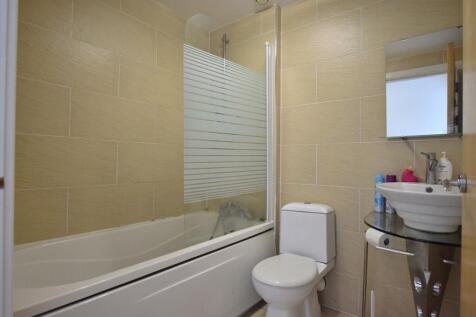 A clean and modern bathroom suite featuring a b...