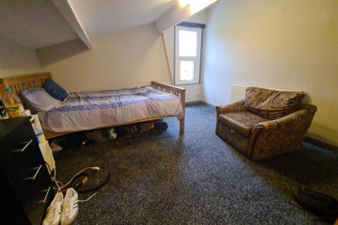 A cozy bedroom featuring a double bed, a comfor...