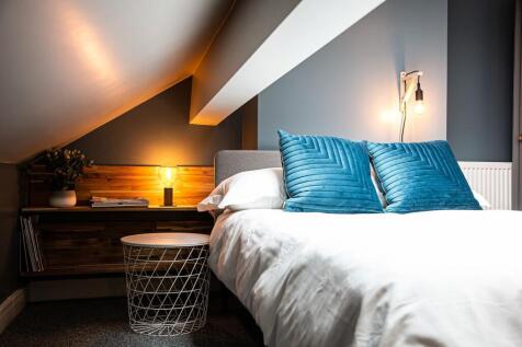 A stylish bedroom featuring a comfortable bed w...