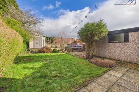 North East facing garden with a mixture of grass, decking and flagged areas