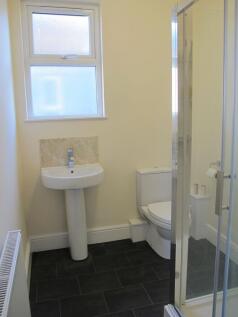 Bright modern bathroom with shower and fixtures...
