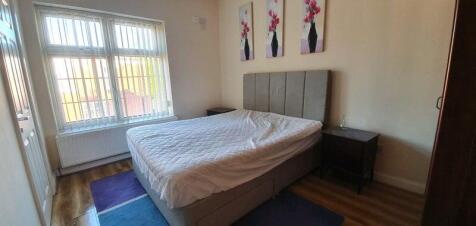 Bright bedroom with upholstered double bed...