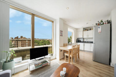 Bright open-plan living area with large windows sh