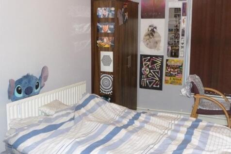 Cozy bedroom with a double bed, striped bedding...