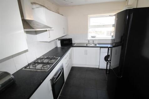 Modern kitchen with sleek white cabinets....
