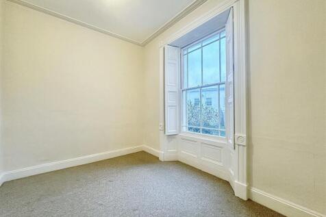 Bright bedroom with large classic sash window...