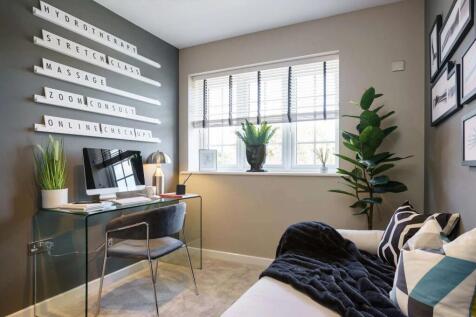 A cozy and well-designed home office space with a desk, chair, and various decorative elements