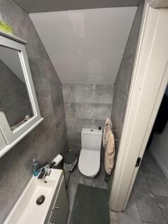 Modern toilet with sleek grey tiling...