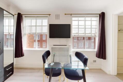 Bright, modern living area with large double sa...