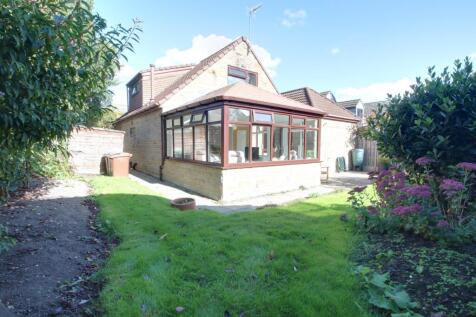 Part of the back garden and conservatory