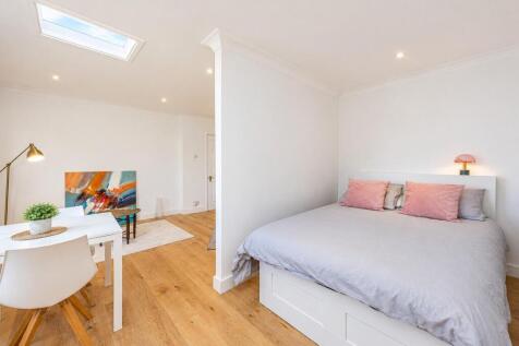 bright minimalist bedroom and living space.jpg