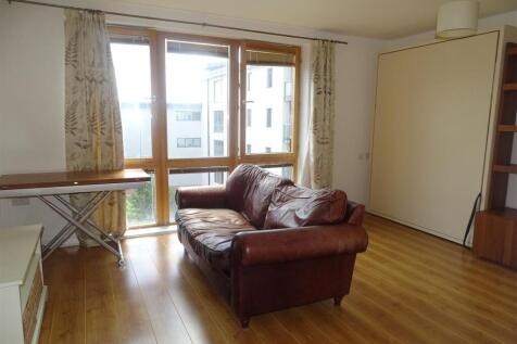 Bright lounge with large windows and sofa...