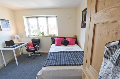 Bright bedroom with study desk and large window...