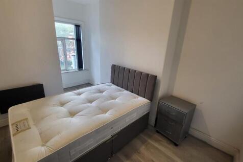 Bright bedroom with modern bed and wood floorin...