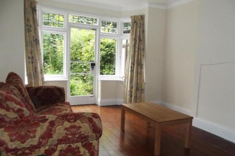 Bright living room with large bay window and gl...