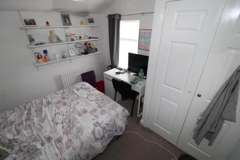 Bright bedroom with desk and ample shelving...