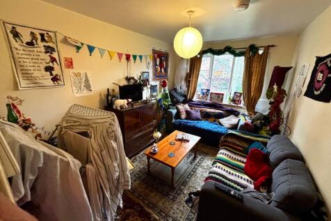 Bright, characterful living room with a large f...