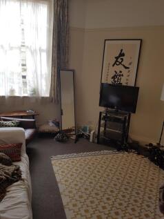 A cozy living room with ample natural light, pe...