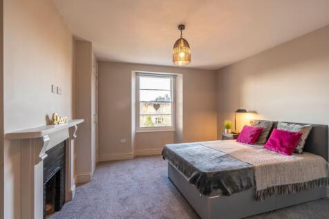 Bright, spacious bedroom with stylish fireplace...