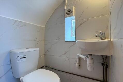 Modern toilet with sleek marble-effect tiling....