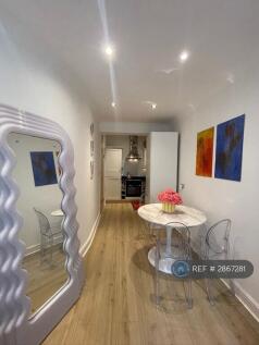 Dining Area With Kitchen In The Background